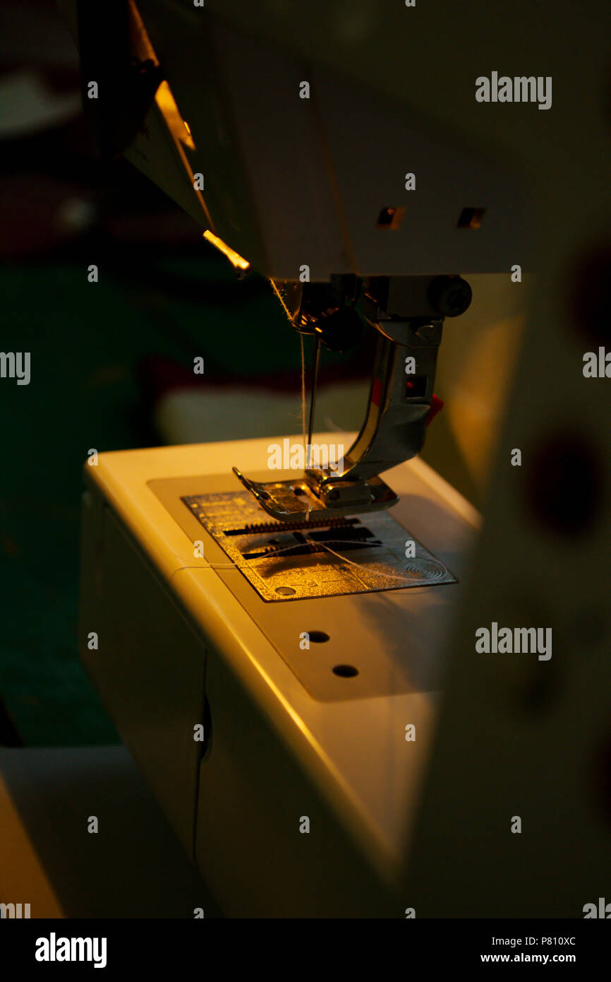 Sewing machine repairs are fabric in industry Stock Photo Alamy