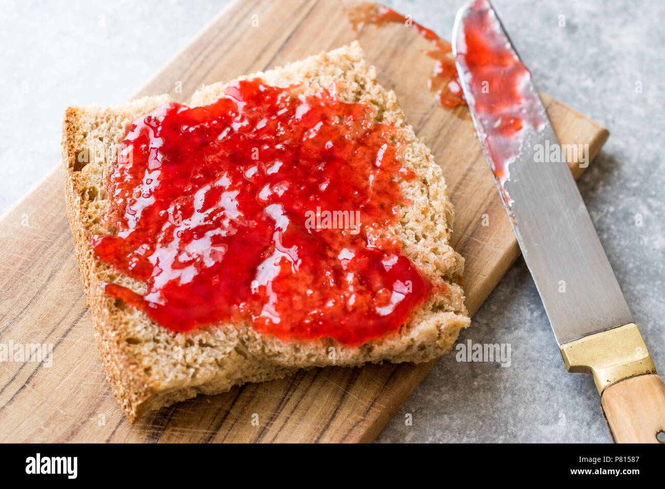 Red Plum Marmalade Jam with Bread and in glass Bowl. Organic Food Stock