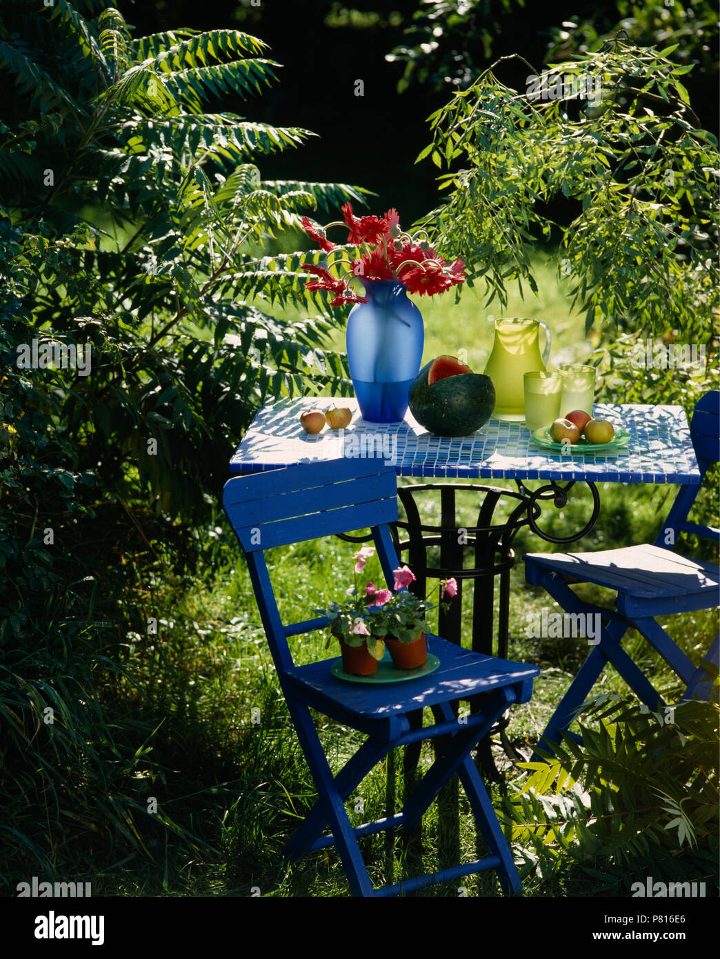 mosaic tile patio table on Bright Blue Folding Chair At Table With Hand Made Mosaic Tiled Top In Shady Corner Of Country Garden Stock Photo Alamy
