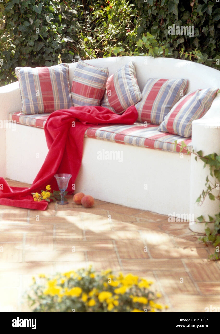 Red Turquoise Striped Cotton Cushions On White Painted Stone Seat