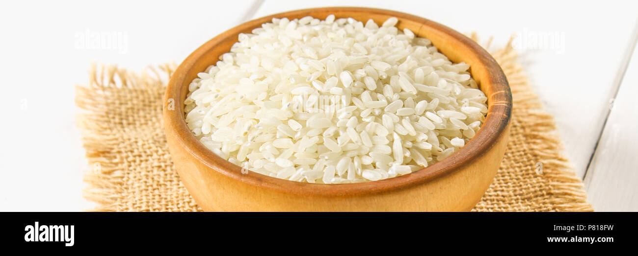 White Items Rice Grains of raw white rice on a white wooden table of boards. Ingredients ...