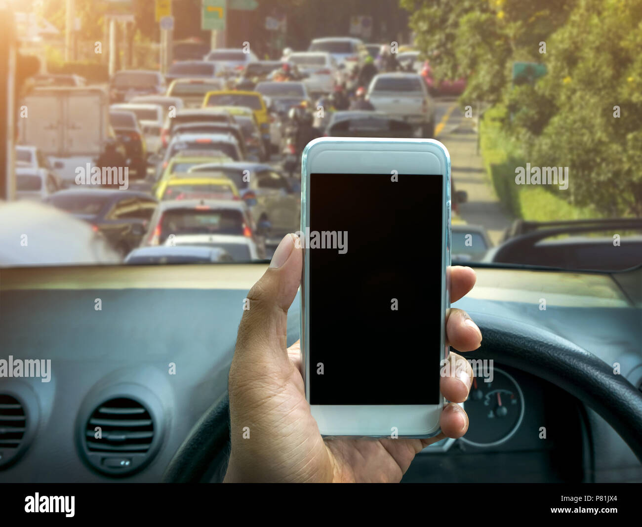 man using a smartphone while driving a car Stock Photo