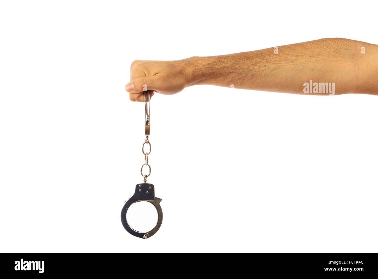 Path Handcuffing Law issues. Handcuffs in a male hand isolated on white background ...