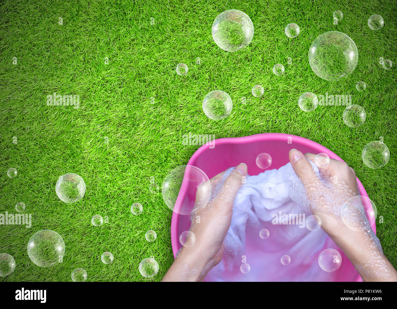 Female Hand washing clothes in the pink basin with clear Bubble soap Stock Photo Alamy