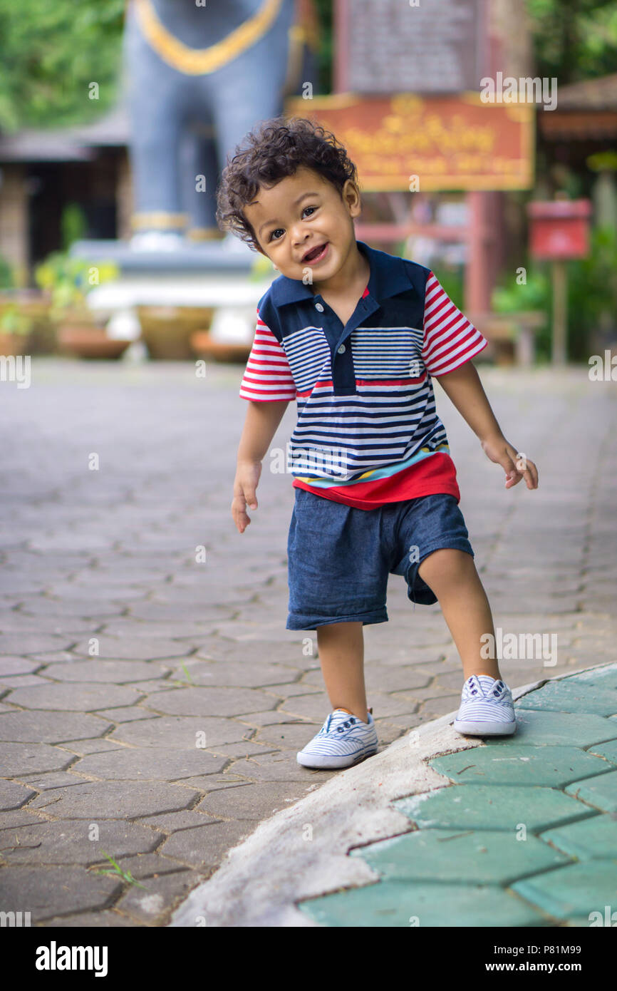 Asian kid with curly hair looking pose when being photographed. With bright emotions smiling Stock Photo - Alamy Asian kid with curly hair looking pose when being photographed. With bright emotions smiling Stock Photo - Alamy