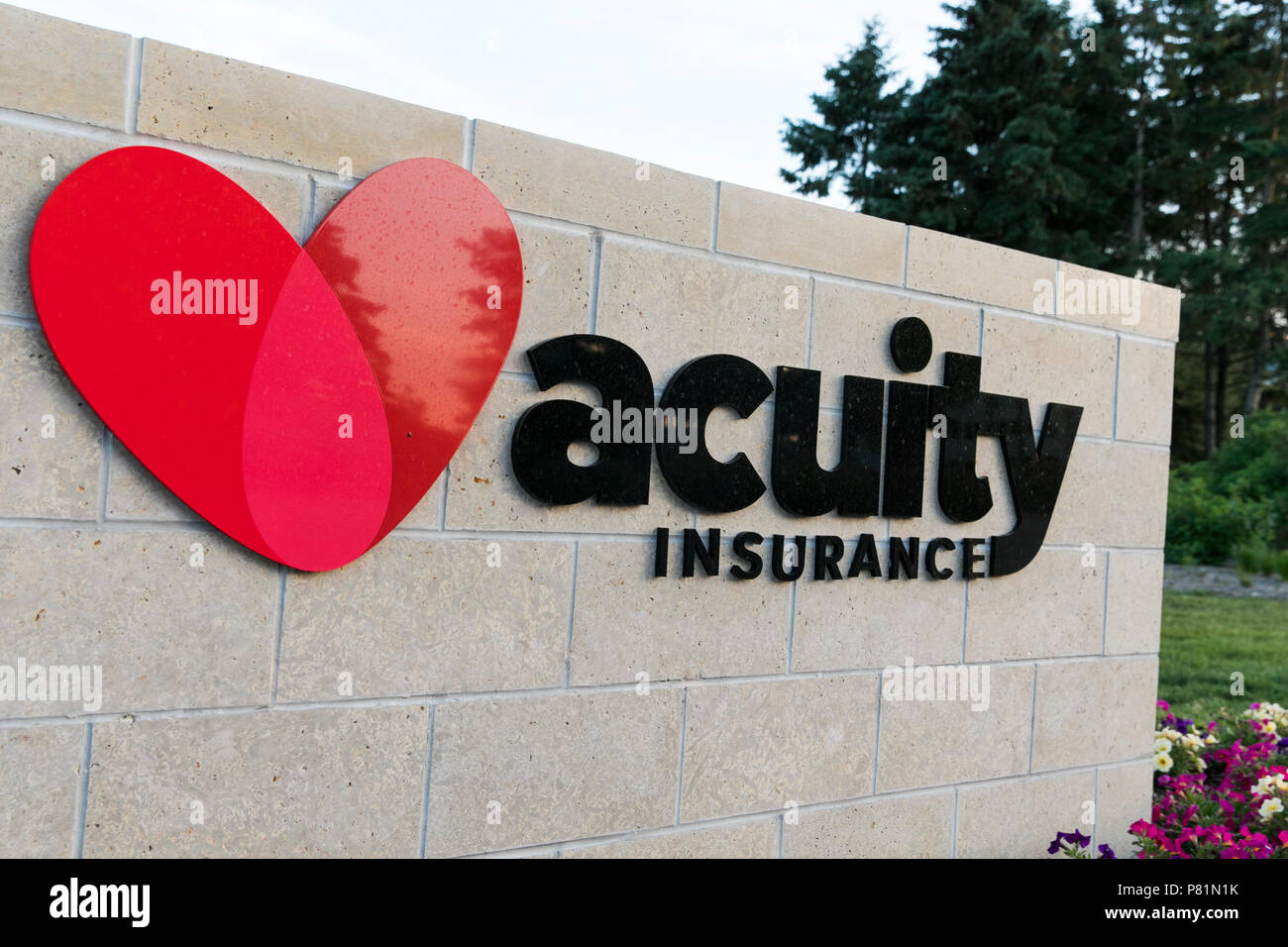 A logo sign outside of the headquarters of Acuity Insurance in