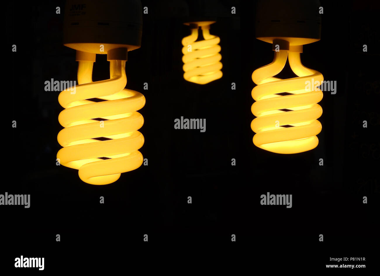 Three light bulb turn on with black background Stock Photo Alamy