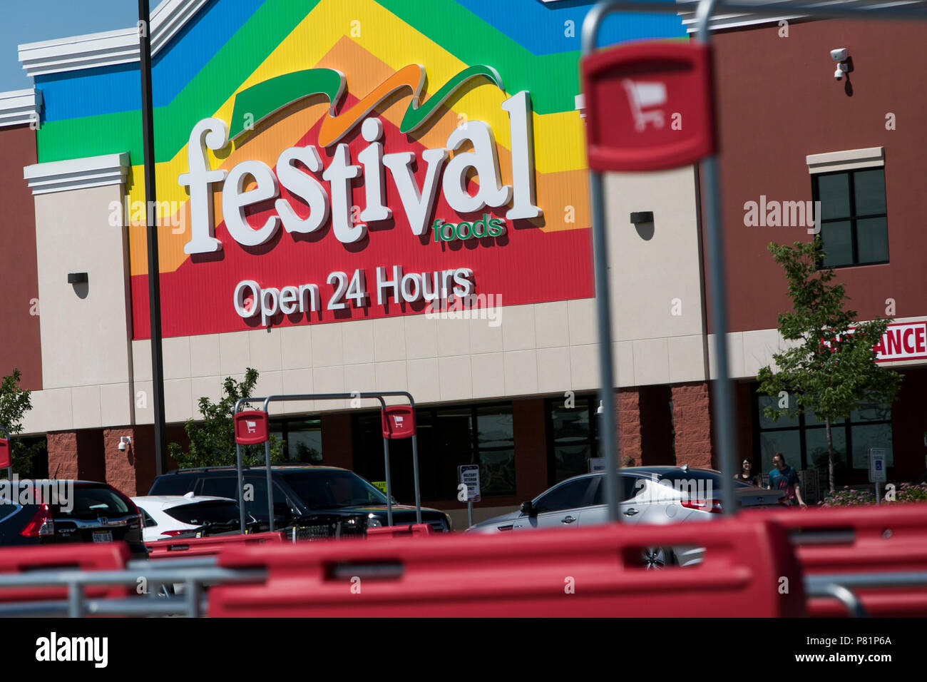 A logo sign outside of a Festival Foods retail grocery store in Kenosha