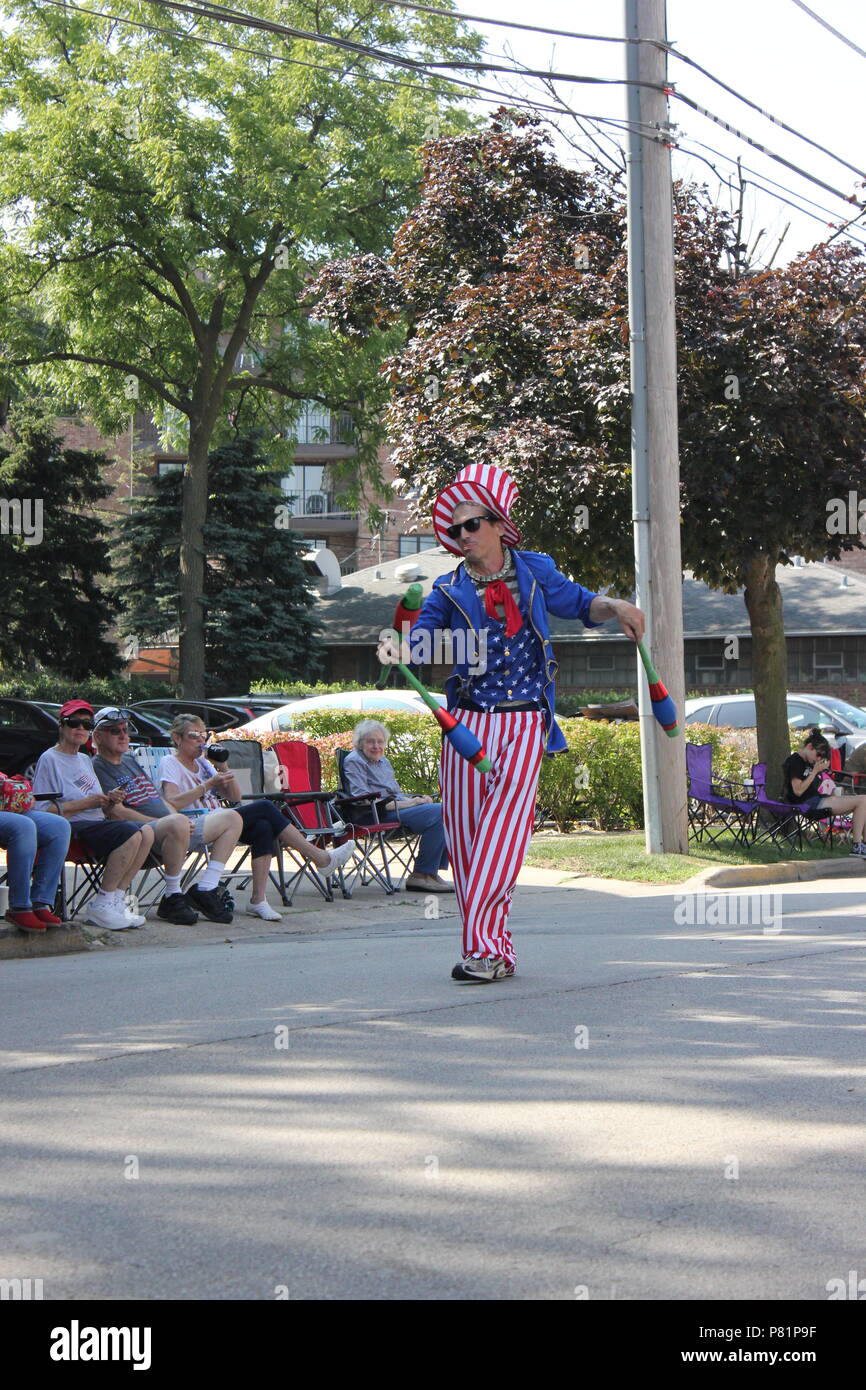 Juggler dressed up in a red white and blue Uncle Sam outfit and