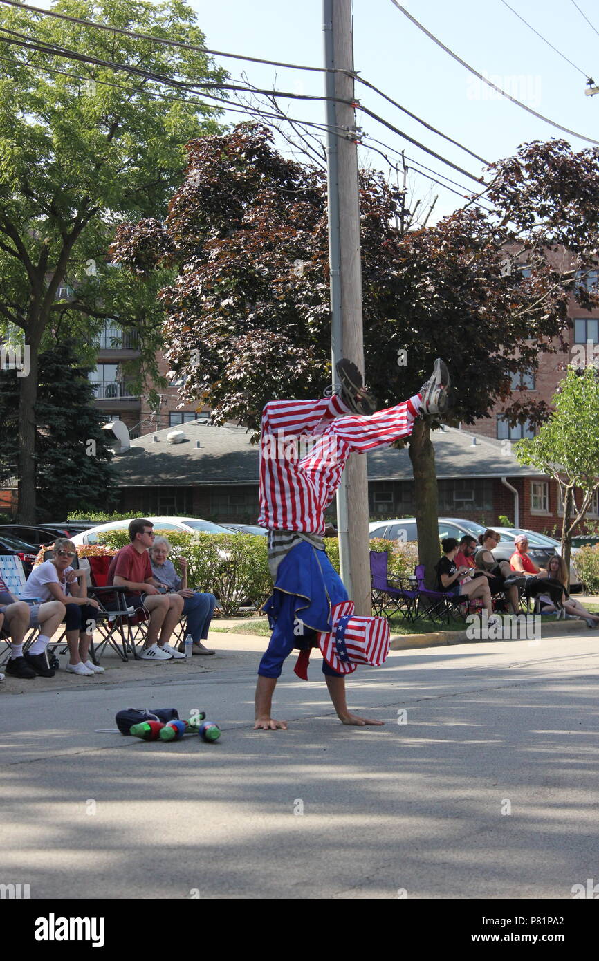 Juggler dressed up in a red white and blue Uncle Sam outfit and
