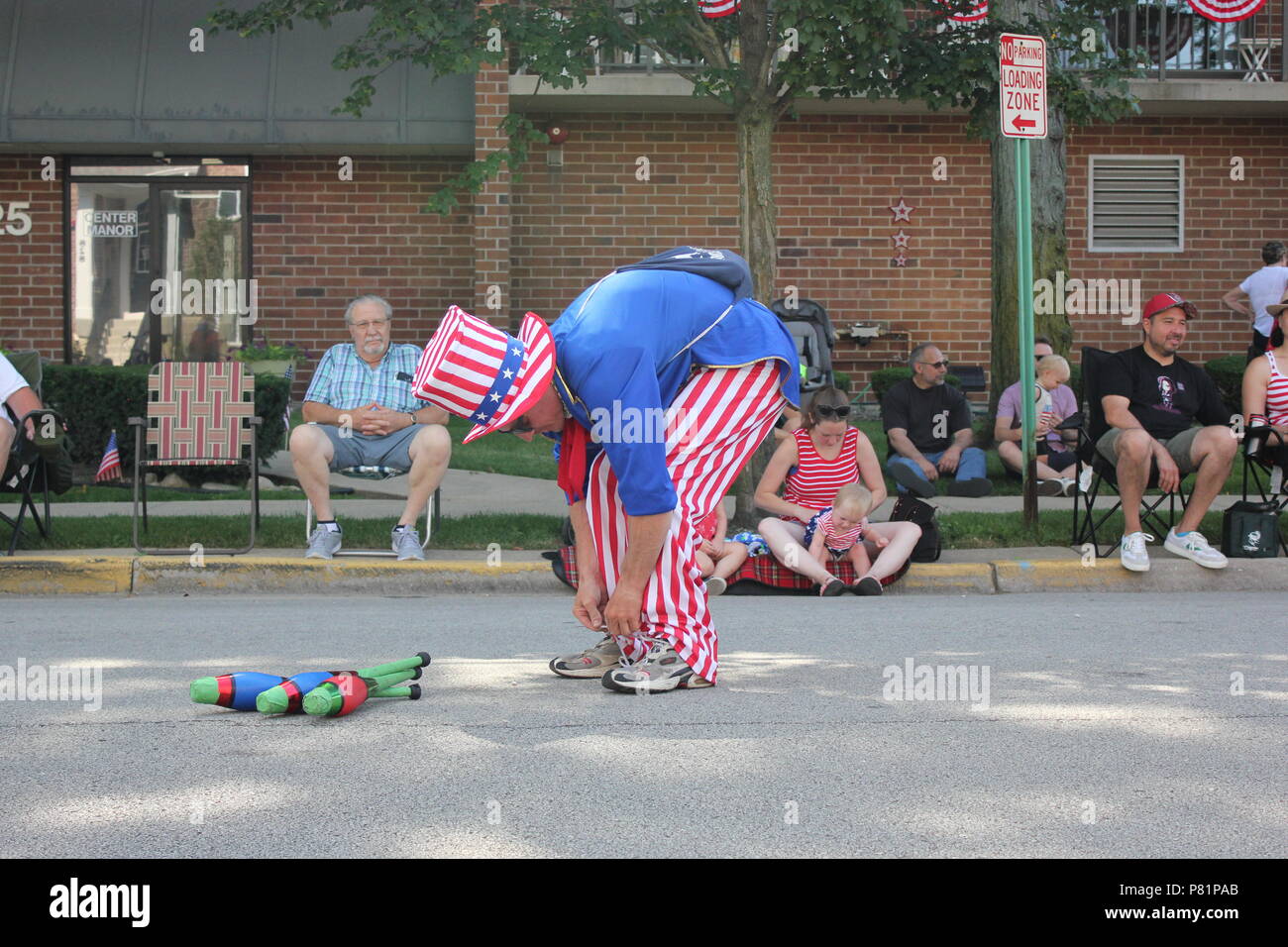 Juggler dressed up in a red white and blue Uncle Sam outfit and