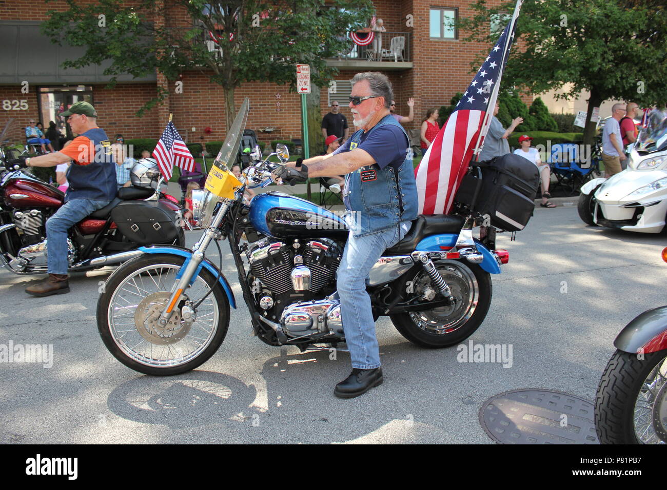 Harley Davidson motorcycle carrying an American Flag during the Fourth of July Parade in Des Plaines, Illinois. Stock Photo