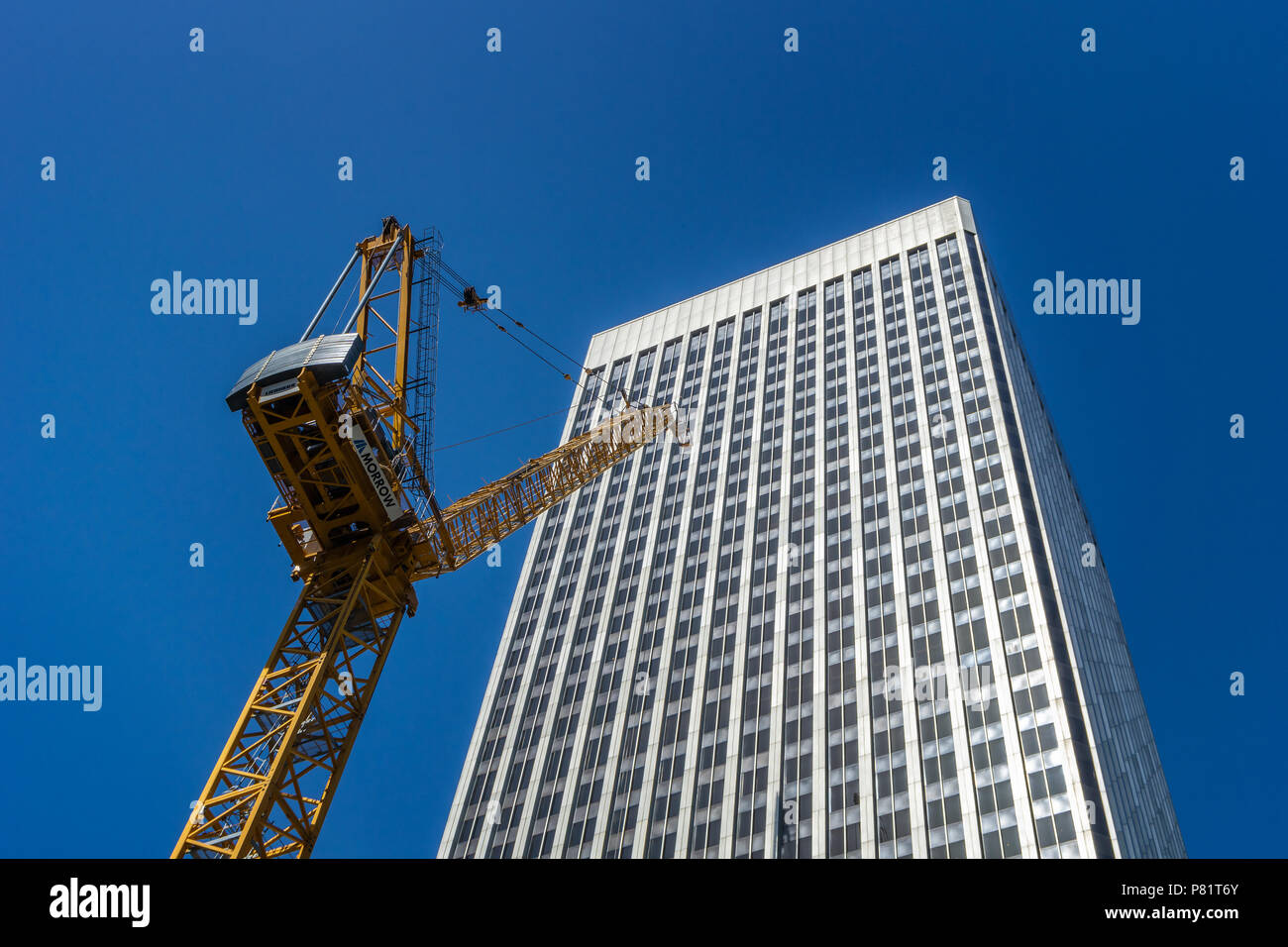Looking up at a crane in front of the Rainier Tower. Construction site of the Rainier square tower, Seattle, WA. Illustrative construction photograph. Stock Photo