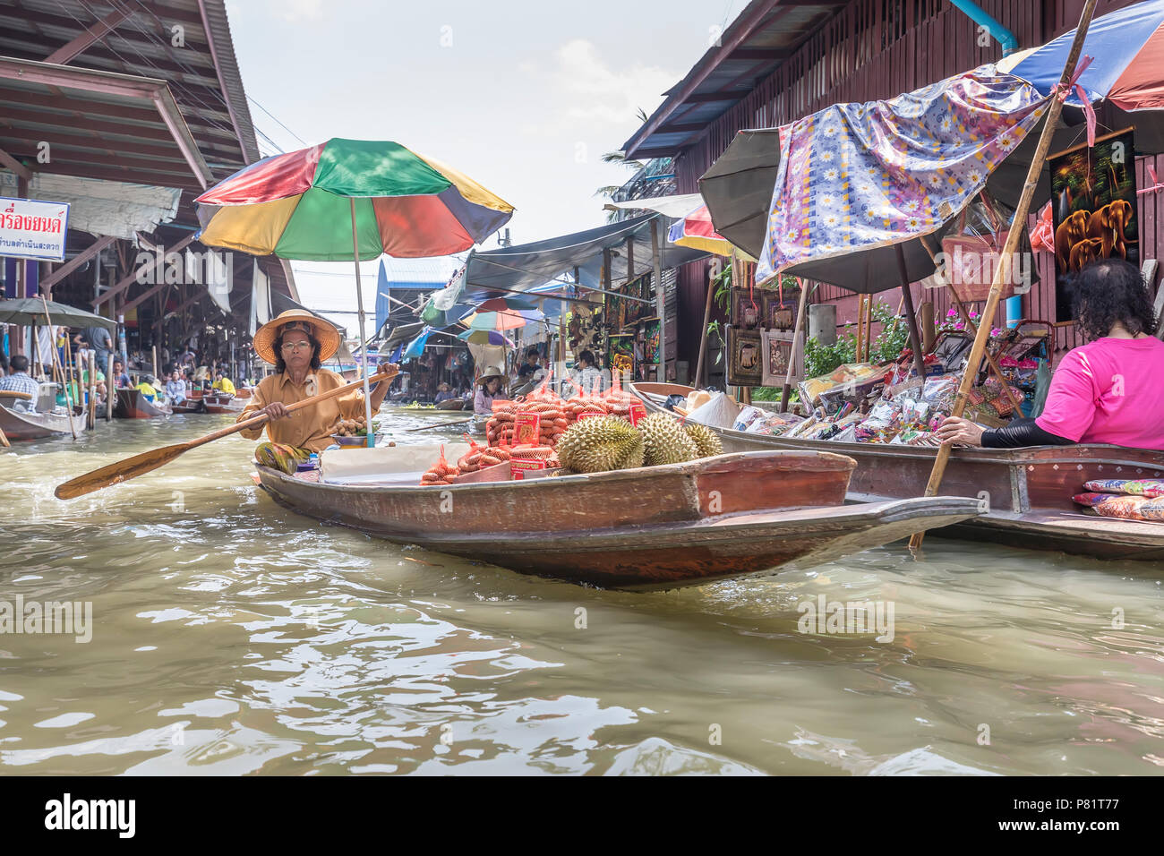 Woman selling food from boat, Tha Kha Floating Market, Thailand Stock Photo