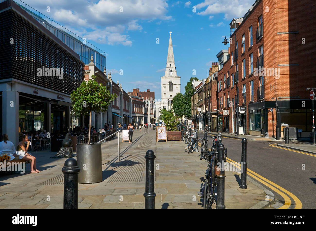 The redeveloped Spitalfields district in East London, UK, looking down Brushfield Street towards the Christ Church, with Old Spitalfields Market Stock Photo