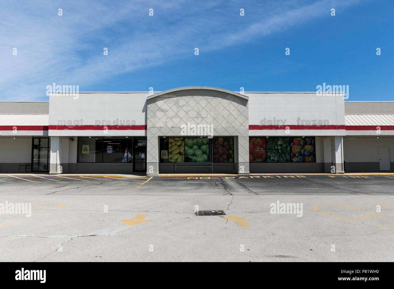 The outline of a logo sign outside of an abandoned SaveALot retail