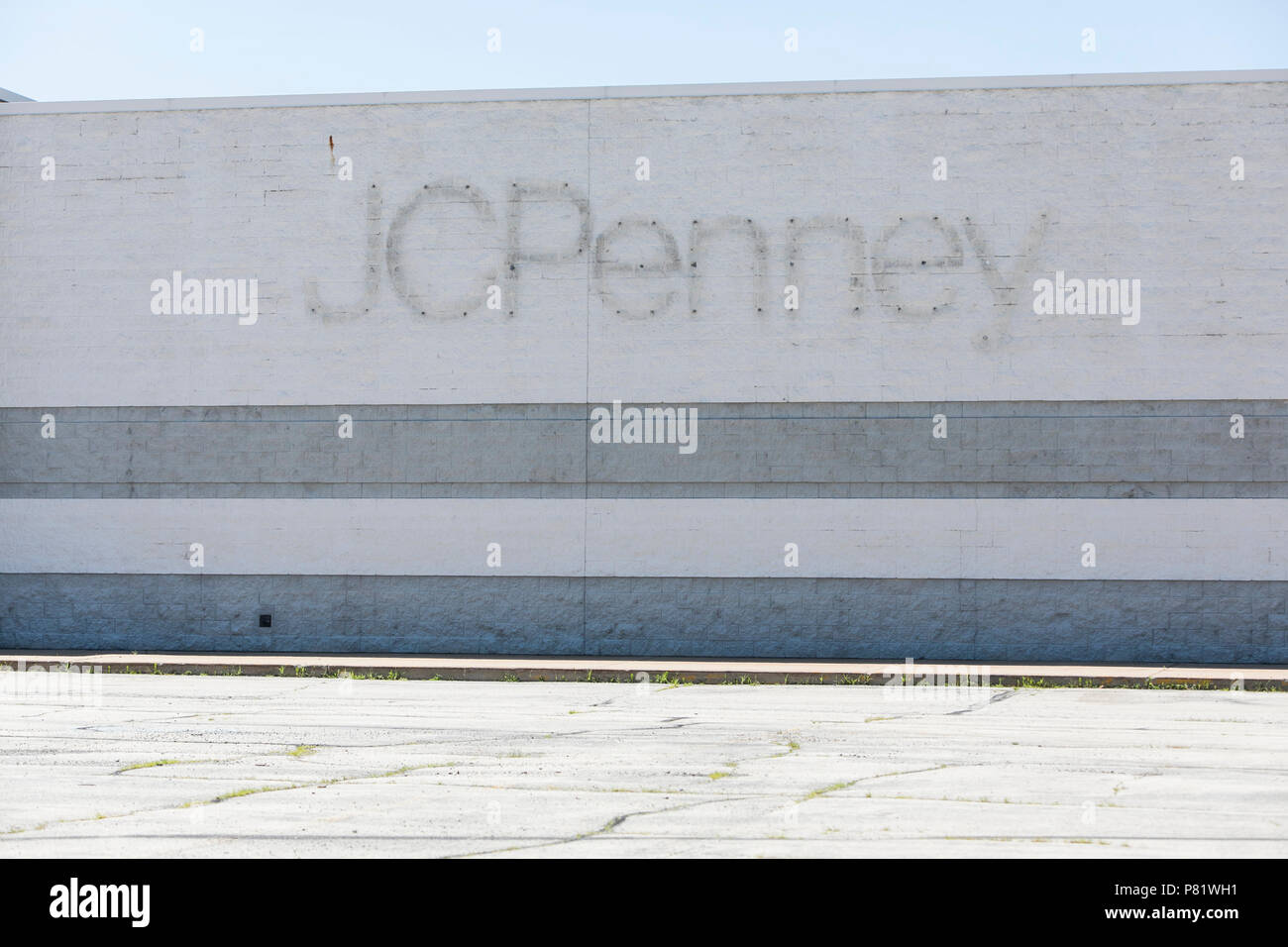 A logo sign outside of an abandoned JCPenney retail store in Oshkosh, Wisconsin, on June 24, 2018. Stock Photo