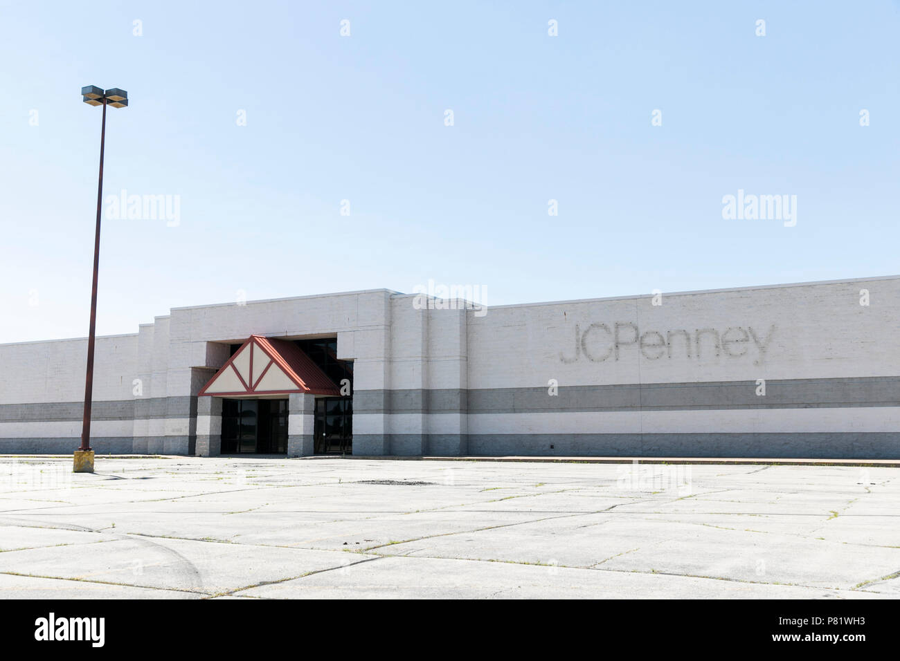 A logo sign outside of an abandoned JCPenney retail store in Oshkosh