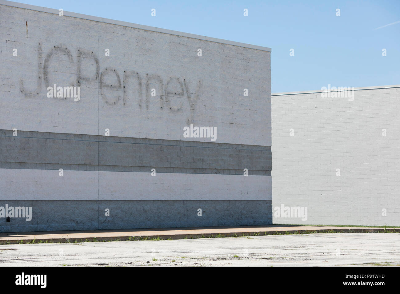 A logo sign outside of an abandoned JCPenney retail store in Oshkosh