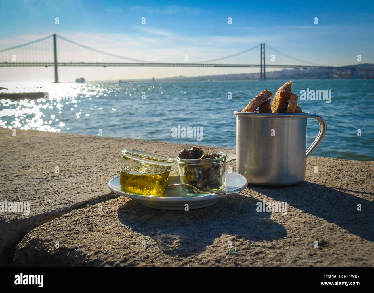 Lisbon, Portugal. Famous bridge Ponte 25 de Abril seen from the Almada side. It spans 2277,64 m across river Tagus. Stock Photo