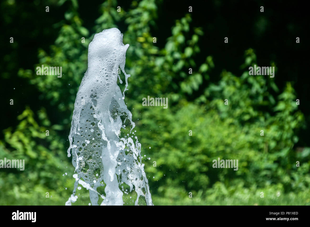 A close snapshot of gushing water with bizarre forms from a fountain in