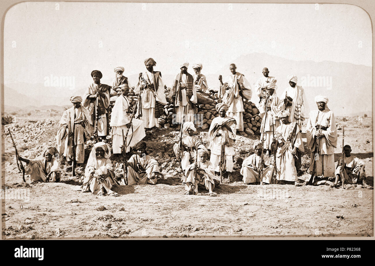 Afridi picket near Jumrood, Khyber & Rotass in distance. Photograph of a group of Afridis taken by John Burke in 1878. Burke accompanied the Peshawar Valley Field Force, one of three British Anglo-Indian army columns deployed in the Second Afghan War (1878-80), despite being rejected for the role of official photographer. He financed his trip by advance sales of his photographs 'illustrating the advance from Attock to Jellalabad'. Coming to India as apothecary with the Royal Engineers, Burke turned professional photographer, in partnership at first with William Baker. Travelling widely in Indi Stock Photo