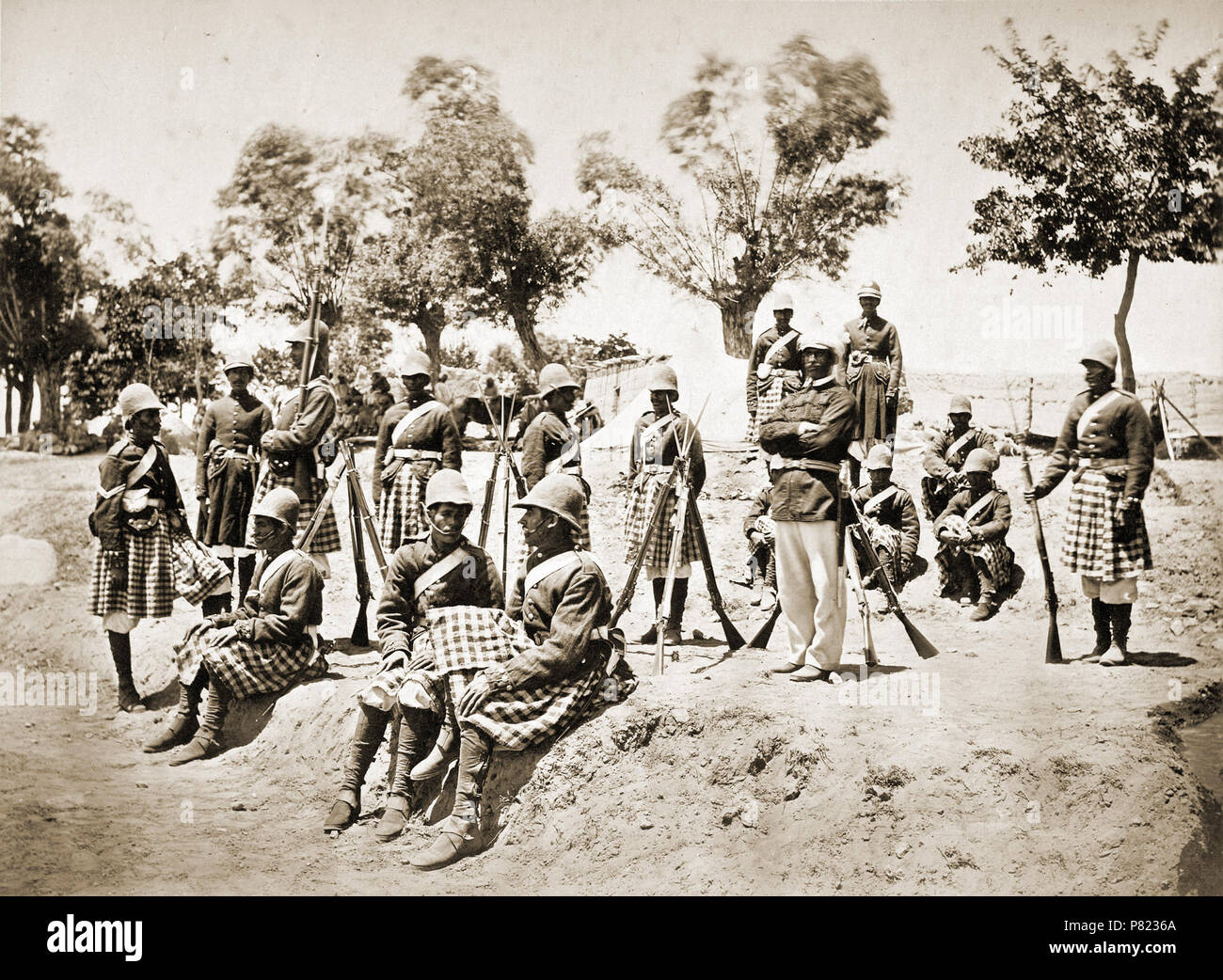 The Amir Yakub Khan's Highlanders [Gandamak]. Photograph of a group of soldiers of the 51st Light Infantry (Yorkshire Regiment) photographed by John Burke in May 1879, around the time that Britain and Afghanistan signed the Treaty of Gandamak. Burke accompanied British forces into Afghanistan in 1878 and covered the events of the Second Anglo-Afghan War (1878-80), becoming the first significant photographer of the country and its people in the process. The British, having taken the Khyber Pass and defeated the Amir Sher Ali's forces, wintered in Jalalabad, waiting for the new Amir Yakub Khan t Stock Photo
