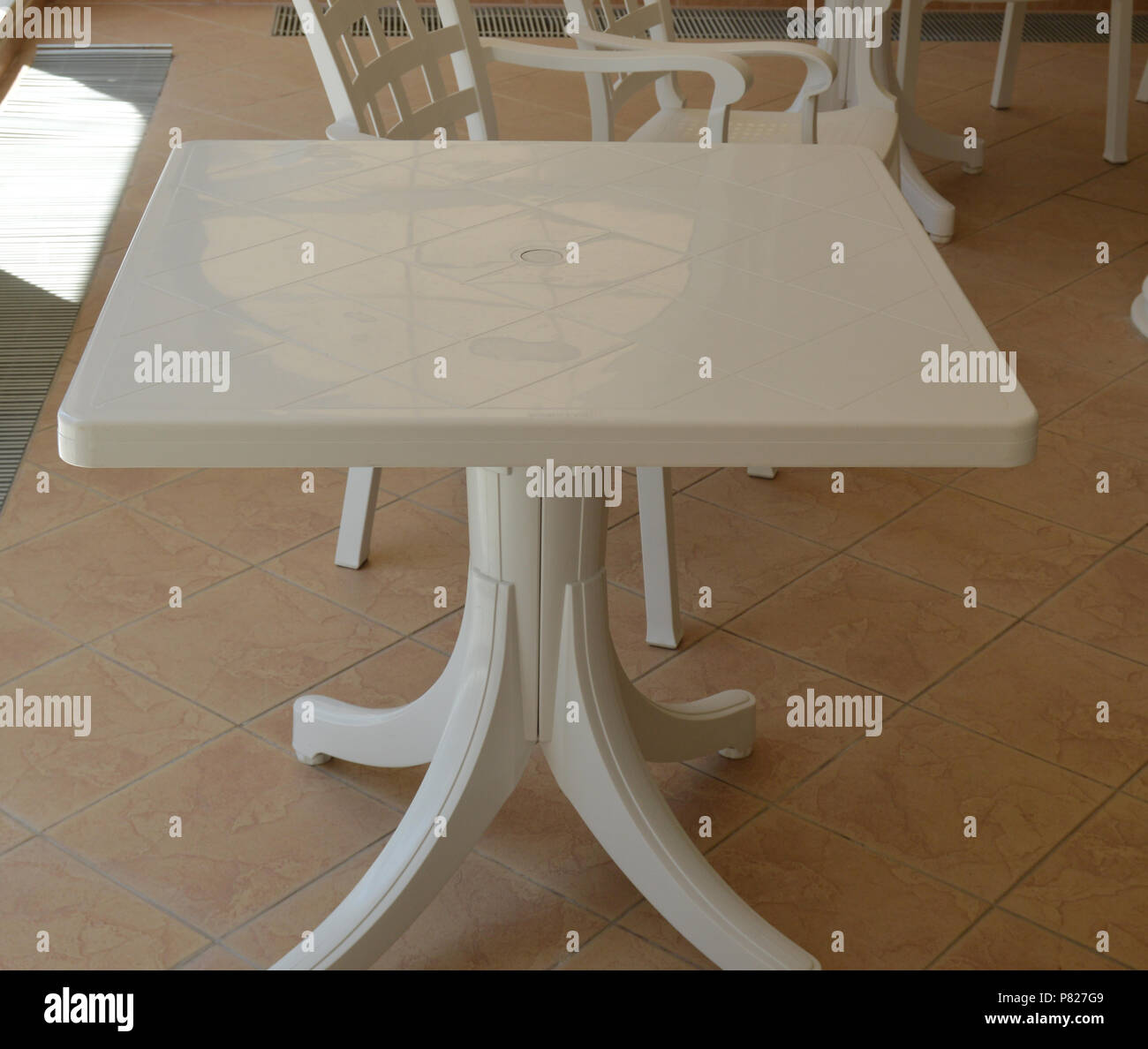 White plastic table stands inside of the room Stock Photo Alamy