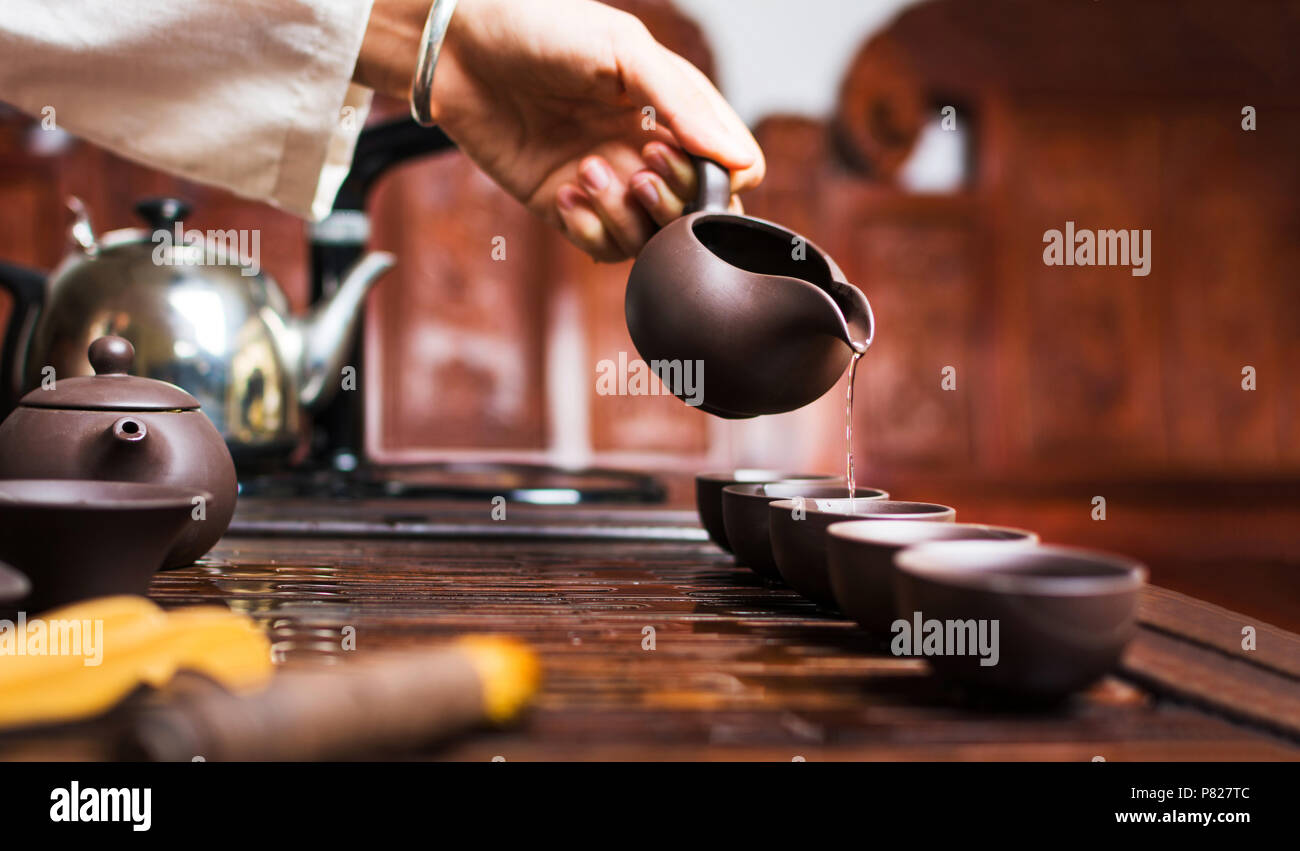 Chinese tea ceremony, Woman pouring traditionally prepared tea Stock Photo
