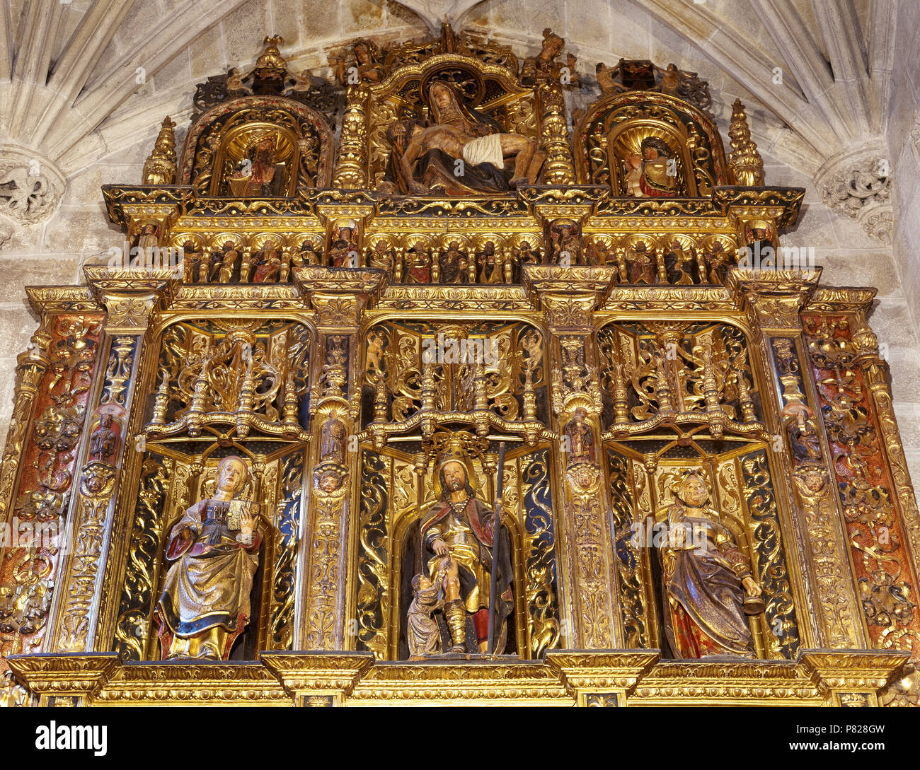 Spain, Galicia, province of La Coruña, Betanzos. Santiago Church. Gothic church built in 15th century by Fernan Perez de Andrade. Altarpiece of the Chapel of St. Peter and St. Paul. Work of the sculptor Cornielles of Holland (16th century). Detail of the upper part. Renaissance style. Stock Photo