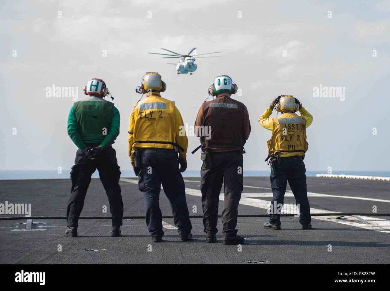 PHILIPPINE SEA (March 29, 2016) A Japanese Maritime Self-Defense Force (JMSDF) H-53 helicopter approaches USS John C. Stennis' (CVN 74) flight deck to transfer JMSDF naval liaison officers. Providing a ready force supporting security and stability in the Indo-Asia-Pacific, John C. Stennis is operating as part of the Great Green Fleet on a regularly scheduled 7th Fleet deployment. Stock Photo
