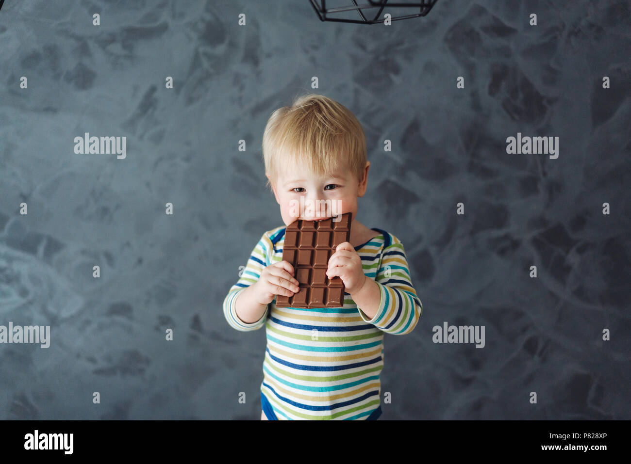 Portrait of an littel boy eating chocolate Stock Photo