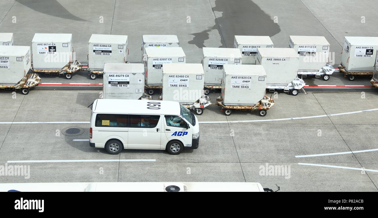 Ground Handling services, Container Loader and Container/pallet Dolly wait for service at Narita Airport. Stock Photo