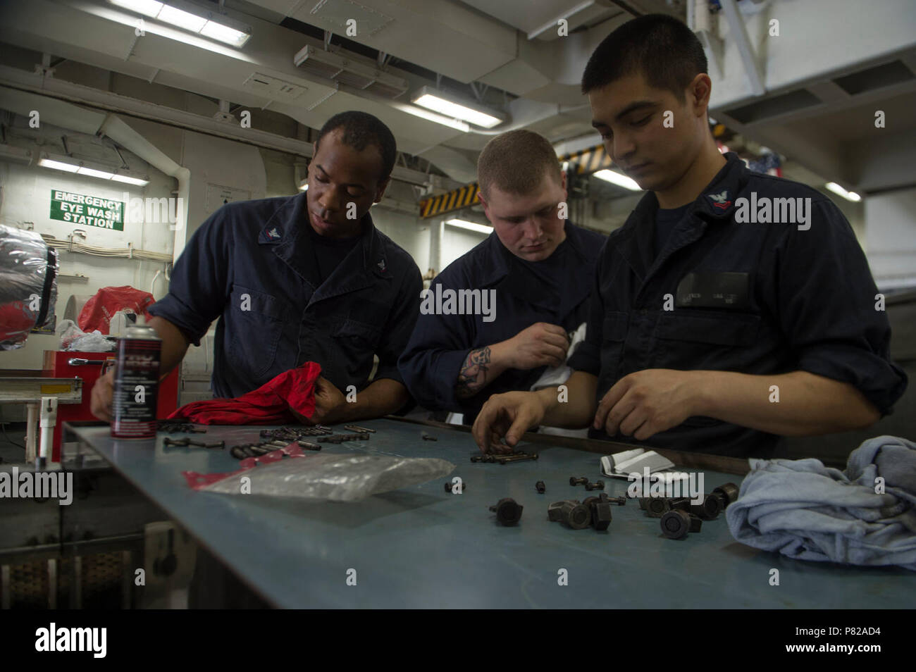 ATLANTIC OCEAN (June 3, 2016) - Aviation Machinist's Mate 3rd Class Sevan Woods, Aviation Machinist's Mate Airman Vincent Weinberg and Aviation Machinist's Mate 2nd Class Steven Vasquez, Sailors on board the aircraft carrier USS Dwight D. Eisenhower (CVN 69), prepare tools to reassemble the afterburner of a F/A-18 E/F Superhornet. Dwight D. Eisenhower is currently underway as part of CSG 10 deployment in support of maritime security operations and theater security cooperation efforts in the U.S. 5th and 6th Fleet areas of responsibility. With CVN 69 as the flagship, strike group assets include Stock Photo