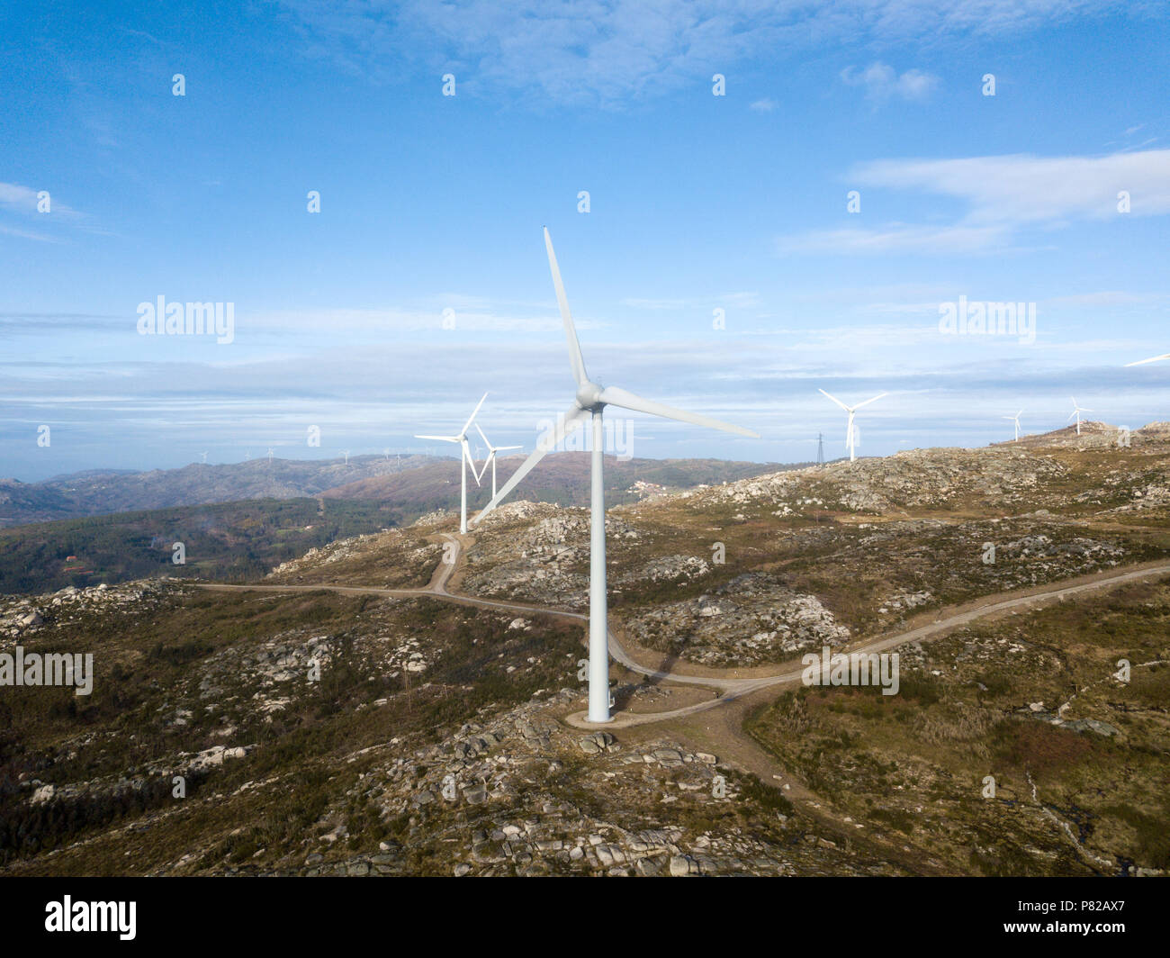 Wind energy turbines, in a landscpae over a beautiful blue sky Stock ...