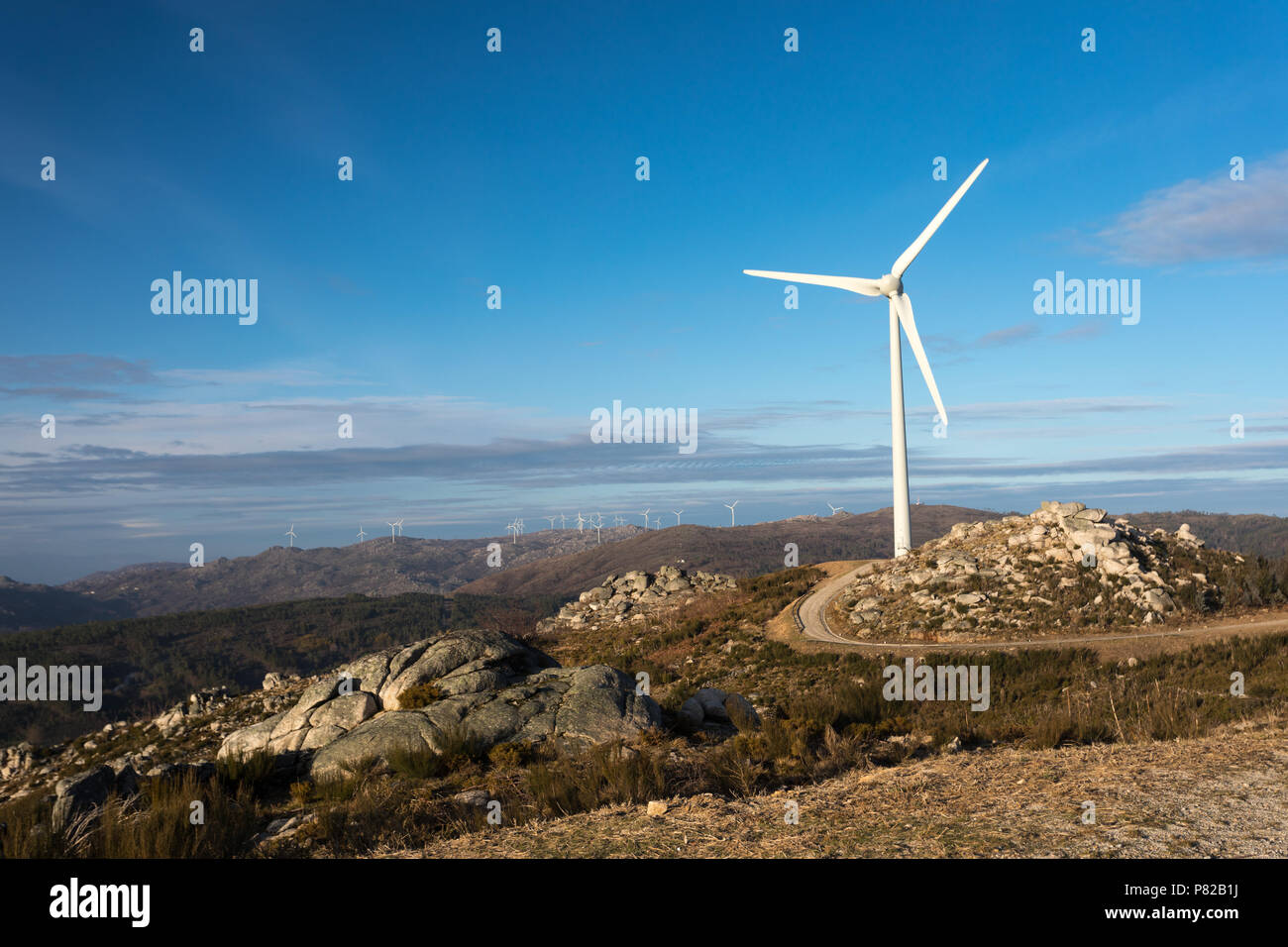 Wind energy turbines, in a landscpae over a beautiful blue sky Stock ...