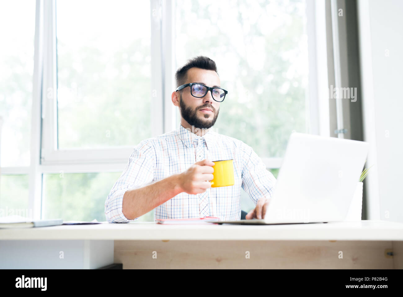 Pensive Entrepreneur Working in Office Stock Photo