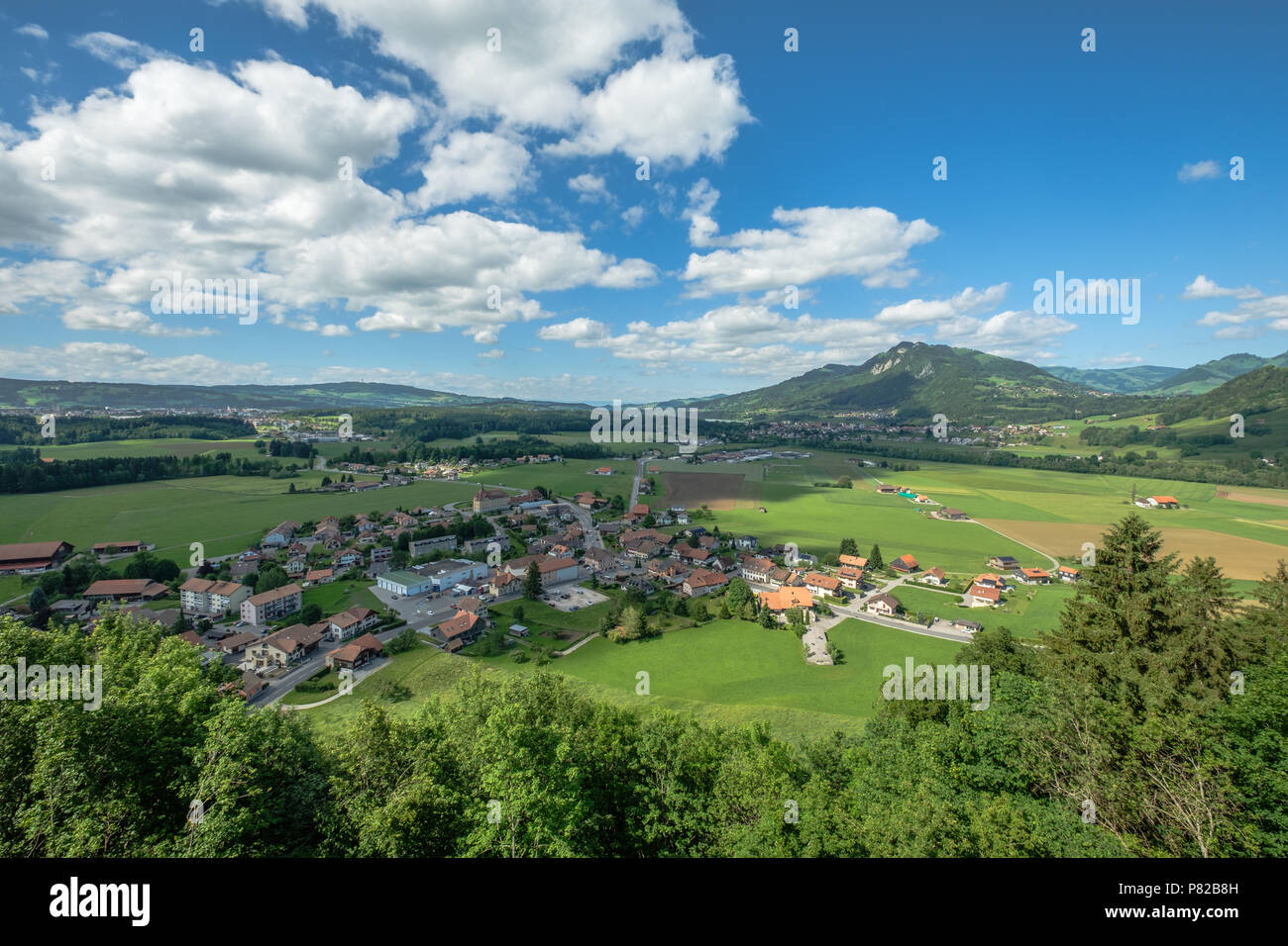 Areal view from the castle of Gruyeres into the valley below surrounded by beautiful alps. Stock Photo