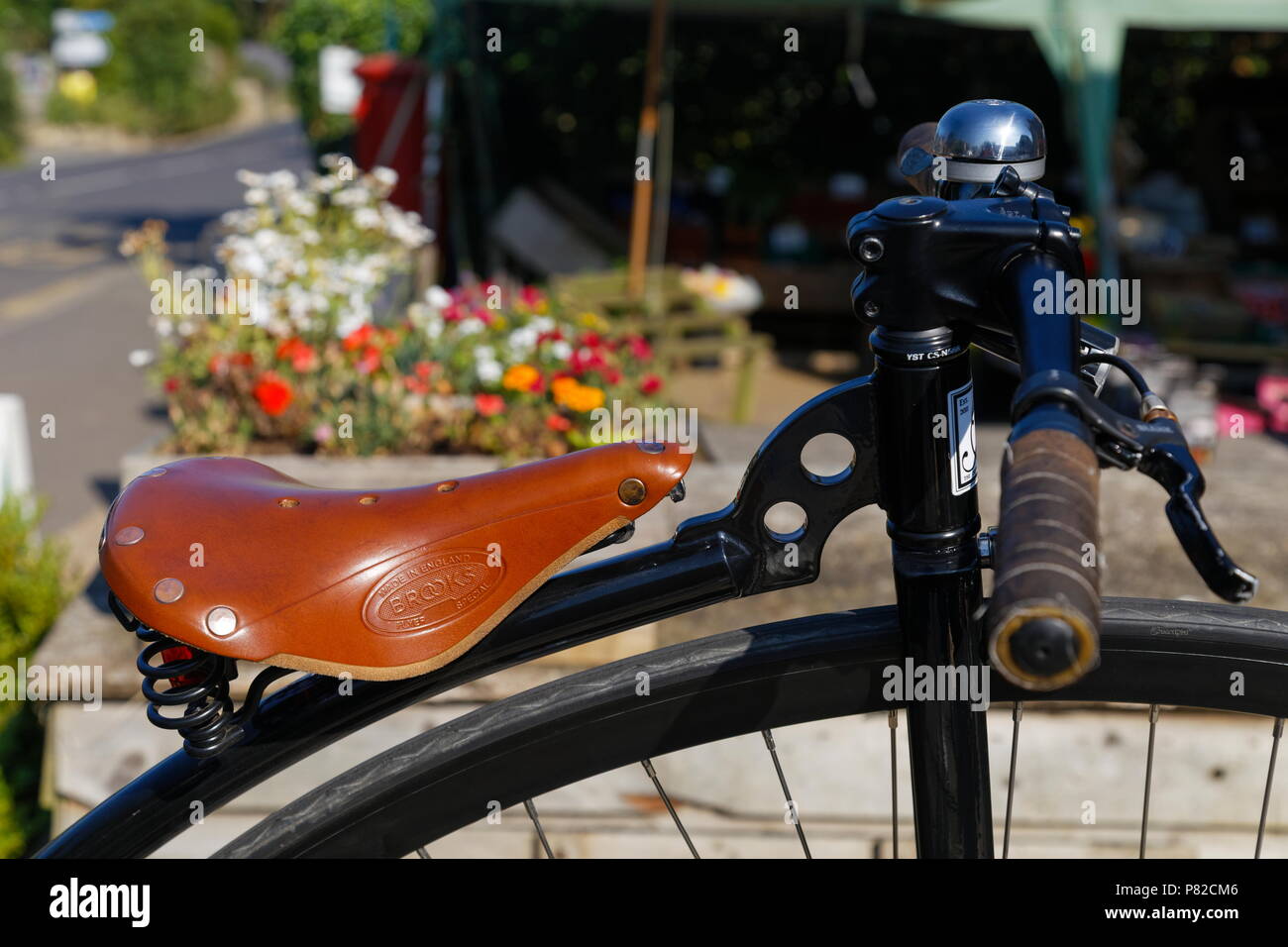 Close up of the saddle and handle bars on a  Penny Farthing in Brighstone Isle of Wight Hampshire Stock Photo