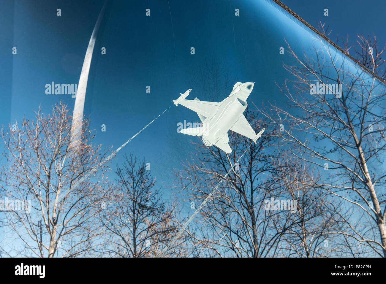 ARLINGTON, Virginia, USA - An F-16 Fighting Falcon etched into a glass panel at the US Air Force Memorial in Arlington, VA. In the background are the main spires of the memorial that are intepretations of the US Air Force Thunderbirds signature bomb burst maneuver. Stock Photo