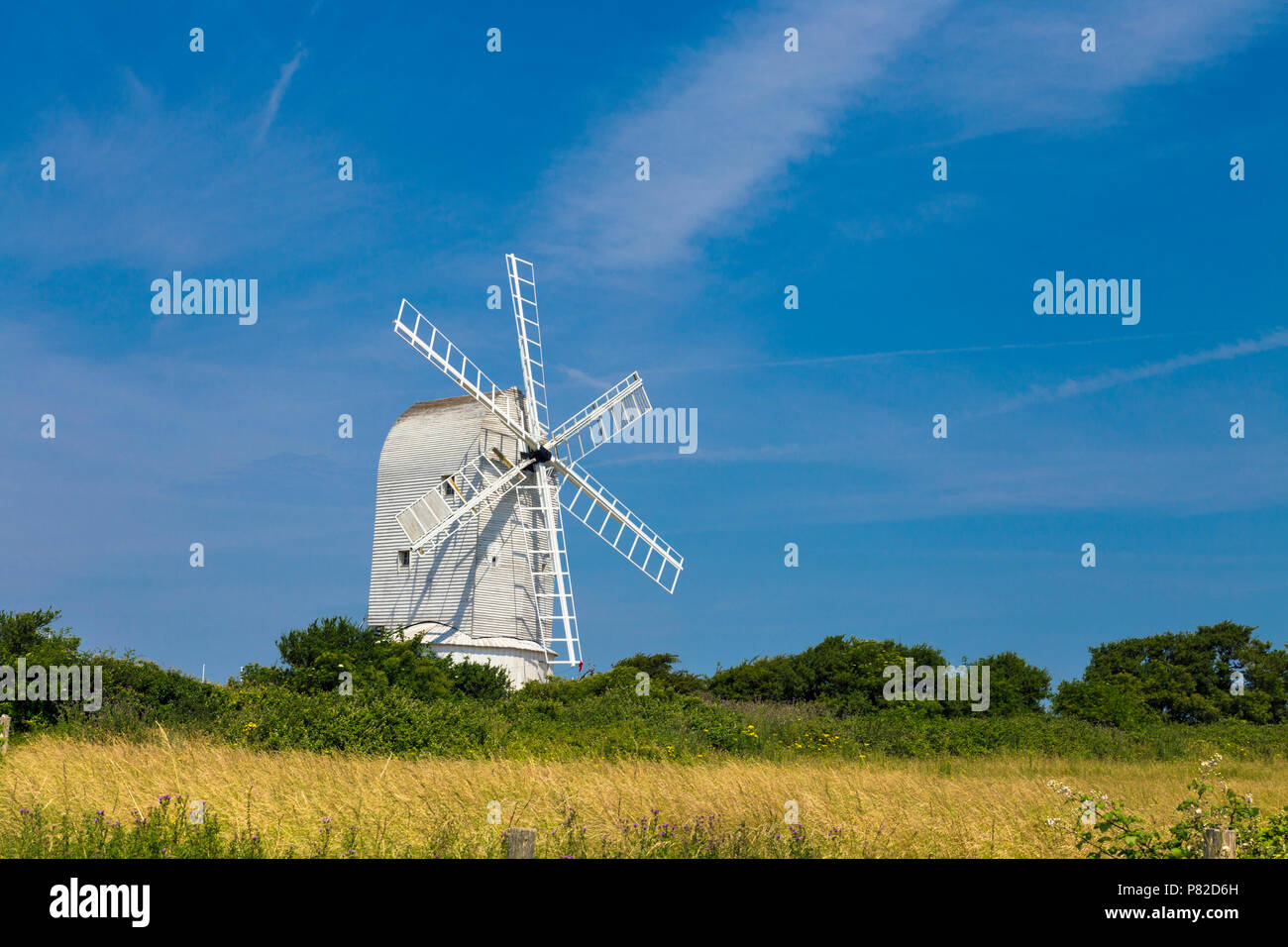 White wooden windmill in a field - Ashcombe Windmill in Kingston near Lewes, South Downs National Park, England, UK Stock Photo
