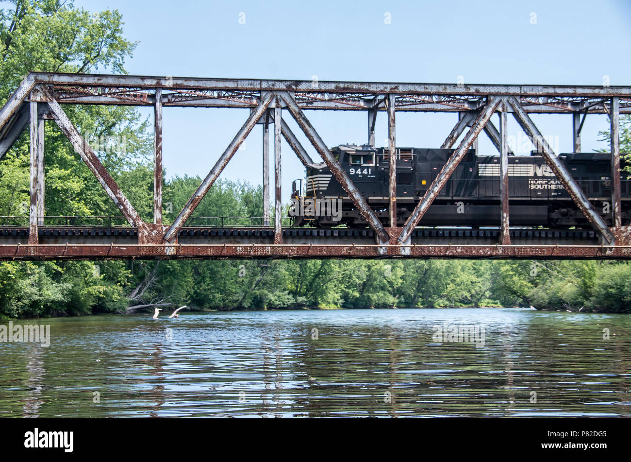 old train trestle with train going across in the wilderness Stock Photo