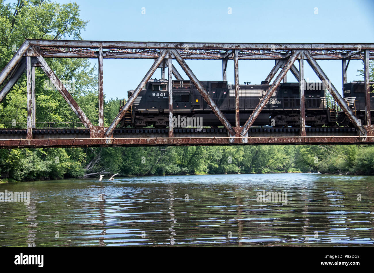 old train trestle with train going across in the wilderness Stock Photo ...