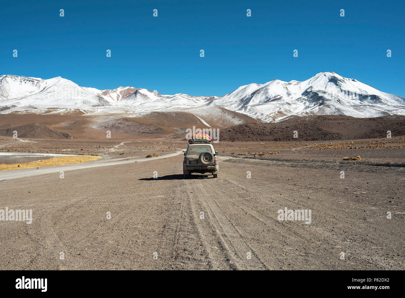 4WD Toyota car driving through the picturesque landscape of The Eduardo Abaroa Andean Fauna National Reserve in Bolivia. Stock Photo