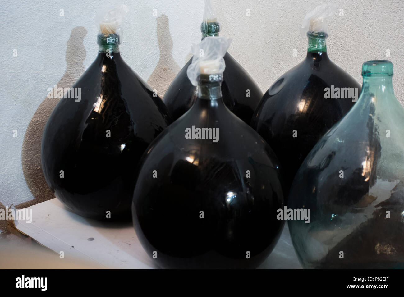 Wine is aged in large glass bottles Stock Photo