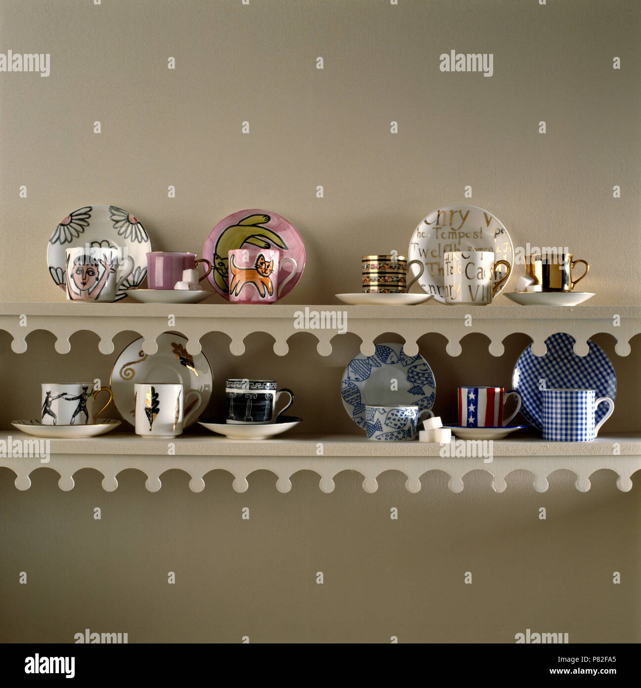 Collection of decorative cups and saucers on painted shelves with a