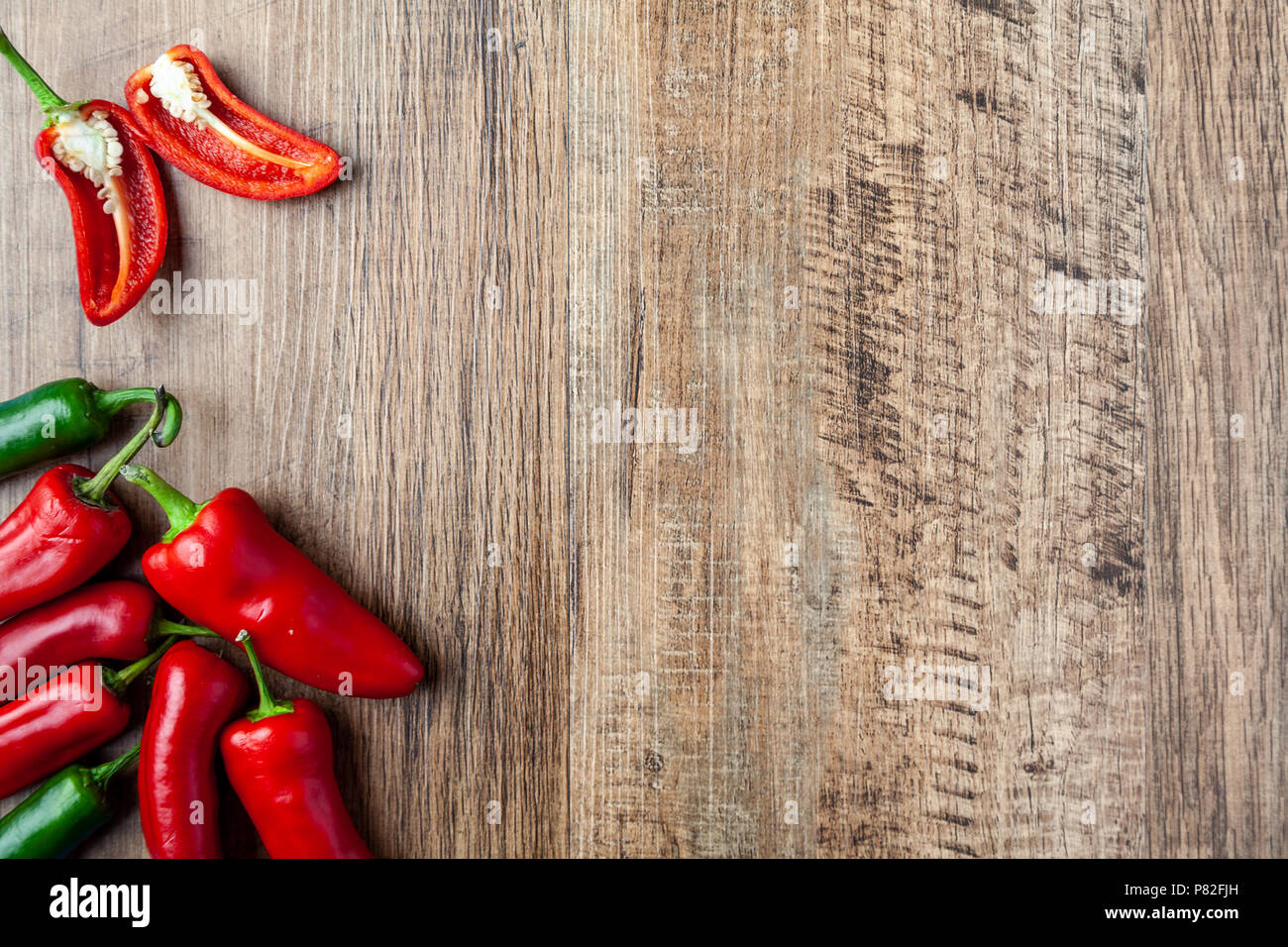 Red and green chilli pepper on wooden table with copy space Stock Photo ...