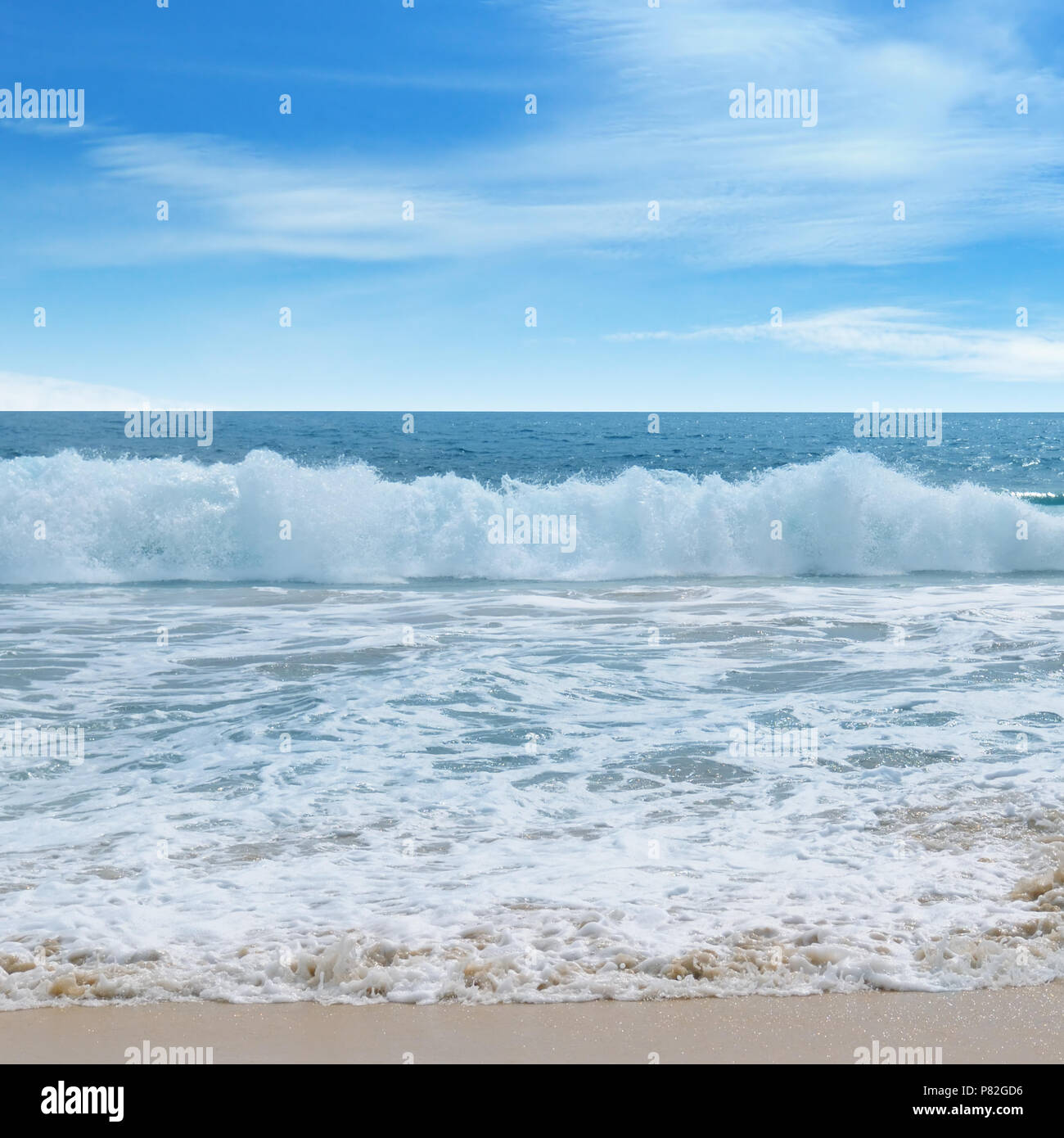 ocean, sandy beach and blue sky Stock Photo - Alamy