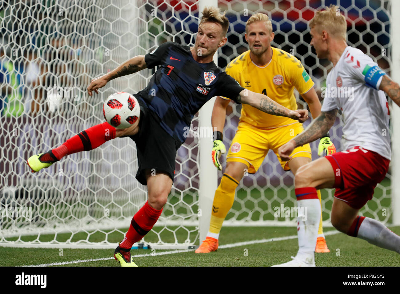 NIZHNY NOVGOROD, RUSSIA - JULY 1: Ivan Rakitic (L) of Croatia national team in action against Kasper Schmeichel and Simon Kjaer (R) of Denmark national team during the 2018 FIFA World Cup Russia Round of 16 match between Croatia and Denmark at Nizhny Novgorod Stadium on July 1, 2018 in Nizhny Novgorod, Russia. MB Media Stock Photo