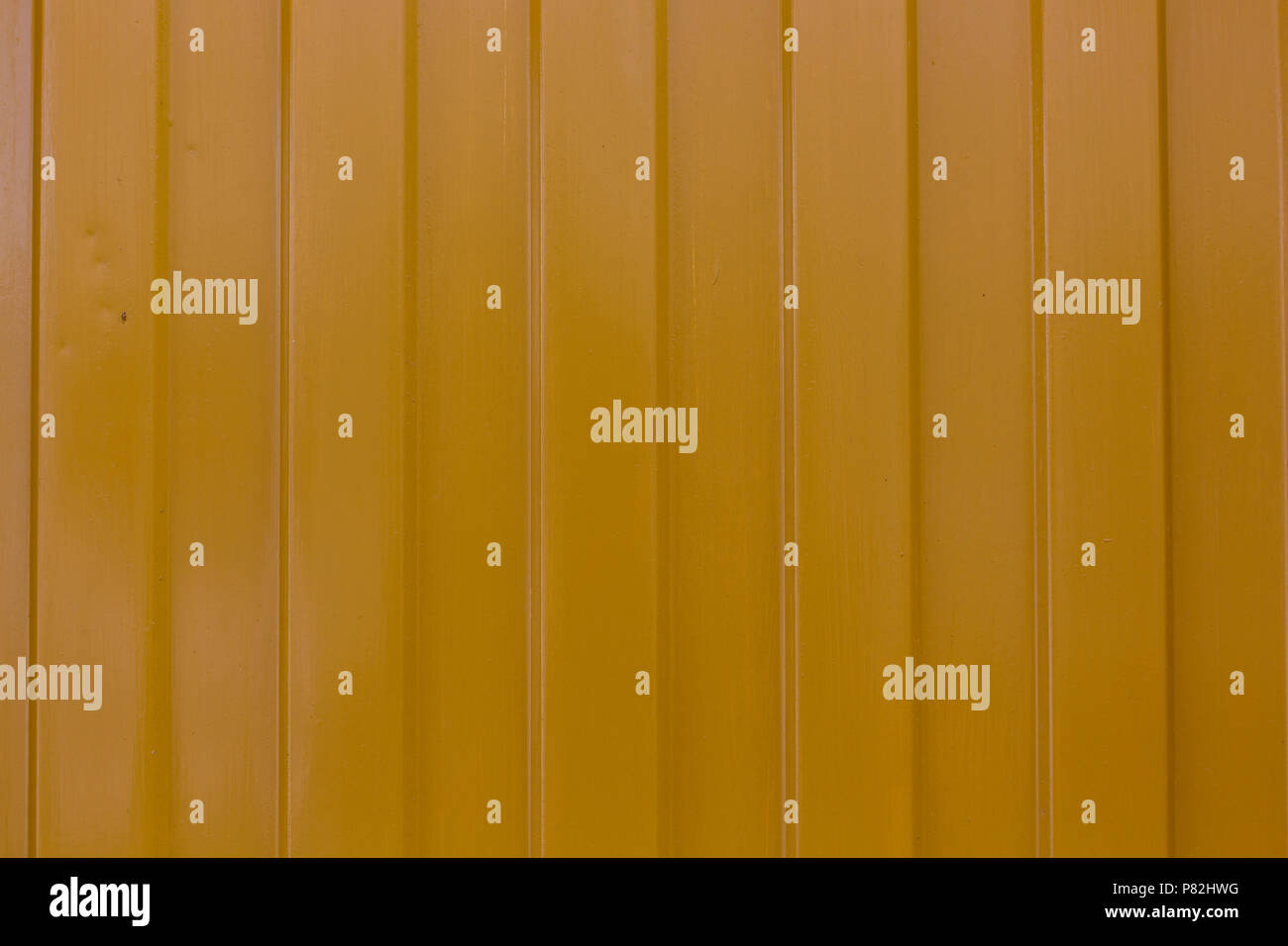 metallic yellow surface with vertical stripes pattern texture background Stock Photo